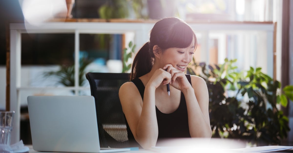 woman-sitting-at-desk-looking-at-documents
