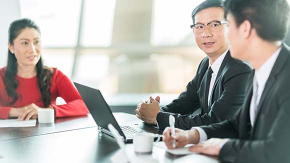 three people at business meeting three people at business meeting
