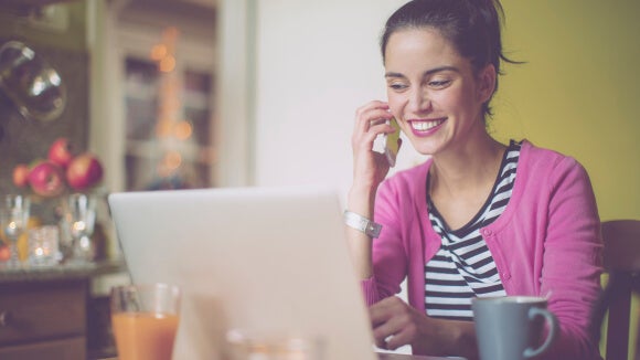 Smiling woman working on laptop smiling-woman-working-on-laptop