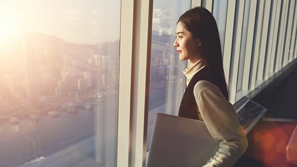 Young woman facing window Young woman facing window