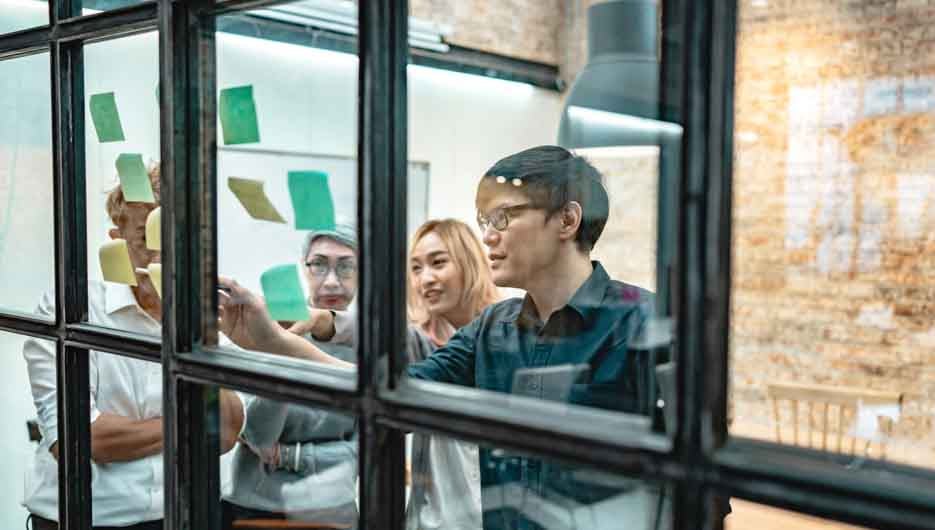 Business asian people meeting at office and use post it notes to